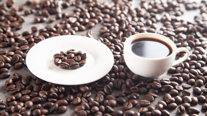 Cup of coffee on coffee beans.
