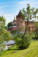 Fototapeta na wymiar Wall of the Kolomna Kremlin of Red Brick and Marinkin Tower