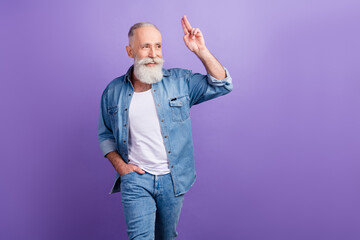 Photo of elderly man happy positive smile show fingers hello salute look empty space isolated over purple color background © deagreez