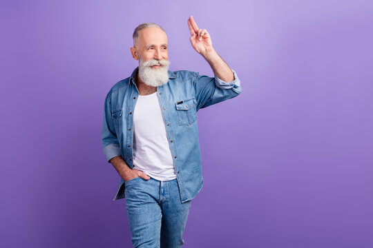 Photo of elderly man happy positive smile show fingers hello salute look empty space isolated over purple color background