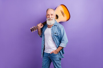 Photo of aged handsome man happy positive smile hold guitar music isolated over violet color...