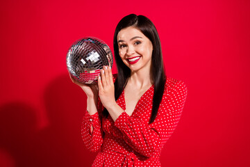 Obraz premium Photo of impressed brunette lady hold ball wear red dress isolated on vivid color background