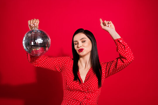 Photo of chic brunette lady dance with ball wear red dress isolated on vivid color background