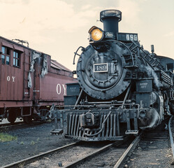 Fototapeta na wymiar Steam locomotive. Train. On steam. Chama New Mexico USA. Rio Arriba County. Cumbres & Toltec Scenic Railroad. Historic Railway track.