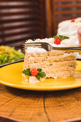 Beautiful White Cake Slice witha Fork on a yellow plate