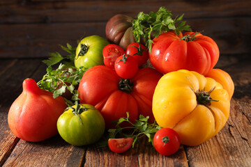 variety of tomatoes on wood background