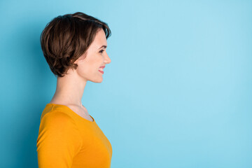 Profile portrait of nice optimistic brunette lady look empty space wear yellow shirt isolated in...