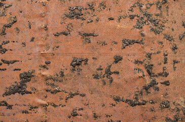 Rustic grunge metal texture and oxidized metal background. An old metal steel panel with an old bitumen stain attached to the steel plate.