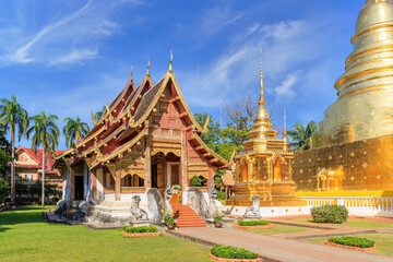 Chapel and golden pagoda at Wat Phra Singh Woramahawihan, famous travel destination in Chiang Mai, Thailand