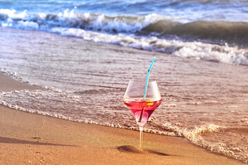 Wine glass with a cocktail by the sea.