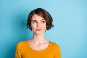 Fototapeta premium Photo of optimistic nice brunette short hairdo lady look empty space wear brown shirt isolated on bright blue color background