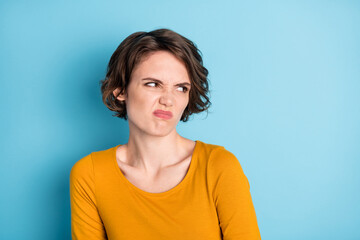 Photo of annoy nice brunette short hairdo lady look empty space wear brown shirt isolated on bright blue color background