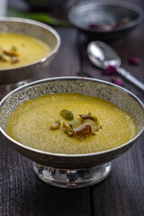 mango-flavored Phirni served in  traditional metal  bowls