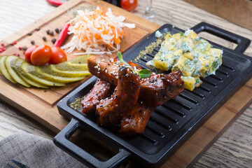 Grilled pork ribs served with marinated vegetables