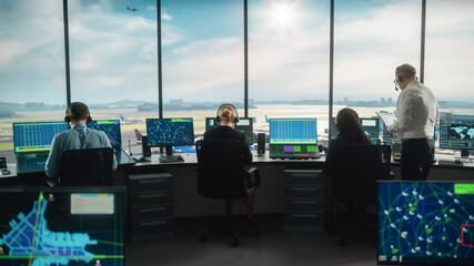 Diverse Air Traffic Control Team Working in a Modern Airport Tower. Office Room is Full of Desktop Computer Displays with Navigation Screens, Airplane Departure and Arrival Data for Controllers. © Gorodenkoff