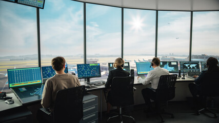 Diverse Air Traffic Control Team Working in a Modern Airport Tower. Office Room is Full of Desktop Computer Displays with Navigation Screens, Airplane Flight Radar Data for Controllers.