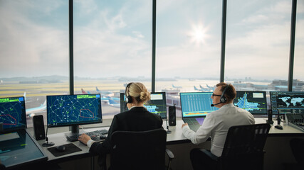 Diverse Air Traffic Control Team Working in a Modern Airport Tower. Office Room is Full of Desktop Computer Displays with Navigation Screens, Airplane Departure and Arrival Data for Controllers.