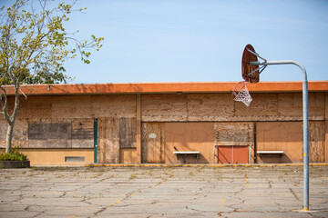 boarded up building and abandoned old basketball court