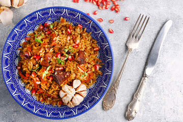 Pilaf and ingredients on plate. National Uzbek pilaf with meat