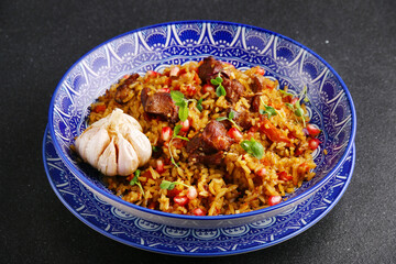 Pilaf and ingredients on plate. National Uzbek pilaf with meat