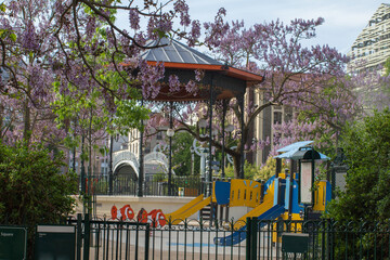Fototapeta na wymiar green entrance of an historic children playground with a kiosk