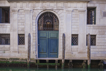Fototapeta premium romantic idyllic view of pier entrance on narrow canal street and renaissance facades of the city of Venice