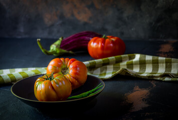 Preparation with vegetables on dark ground in the kitchen	