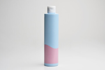 Cosmetic cream , serum, skincare blank bottle packaging with leaves herb, bio organic product. Cosmetics mockup for branding. Beauty makeup product. Blu pink plastic cosmetics container for shampoo. 