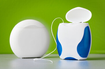 Dental floss on a green background, macro