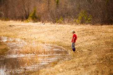 Little girl walking by the water