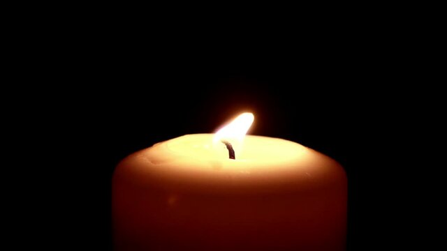 candle on black, close up
