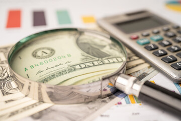 Fototapeta premium Magnifying glass and US dollar banknotes on graph background, Banking Account, Investment Analytic research data economy, trading, Business company concept.