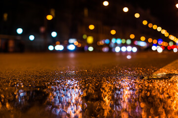 Nights lights of the big city, the main city street in rushhour. Close up view from the level of...
