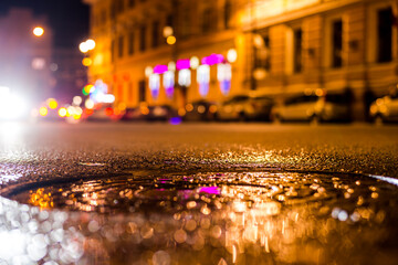 Nights lights of the big city, the city street with sparkling storefronts. Close up view of a...