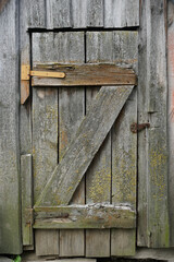 The door from the boards to the cellar. Retro. Old awnings and rusty nails. Vertical shot