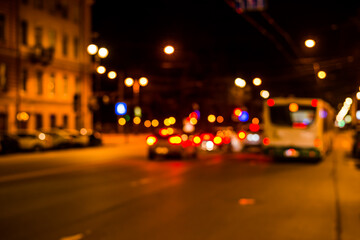 Fototapeta na wymiar Nights lights of the big city, the city street with cars riding on it. Defocused image