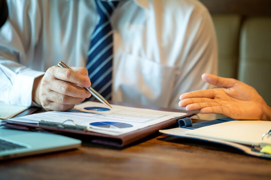 Businesses are offering alternative information to help decision makers in marketing planning. Diverse business team discuss statistical report infographics, charts share