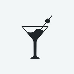 martini glass with olives and straw