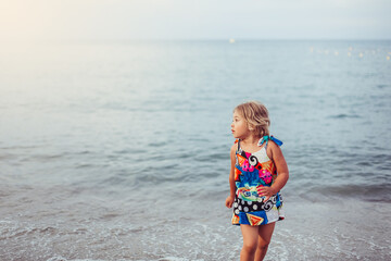 Adorable cute little girl portrait on the beach. Childhood, vacation concept