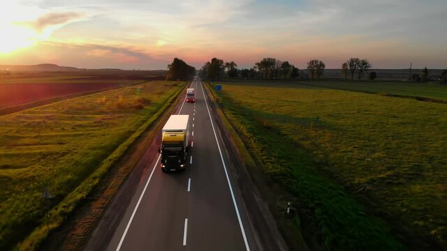 Amazing Aerial Drone View: Semi Trucks Delivering Goods by Road.