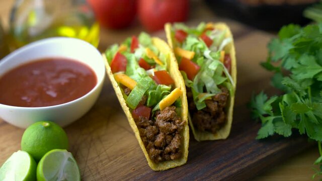 hard shell taco on wooden board with lime