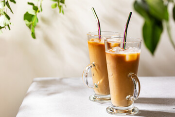 Iced coffee in tall glasses with colorful metal straws
