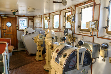 Navigational bridge on abandoned vessel. Old derelict ship wheelhouse. Ship's control device. Russian words: Ahead/Astern, full, half, slow, dead slow, stop, stand by. © Alexey Seafarer