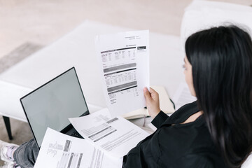 Businesswoman with documents and laptop working at home