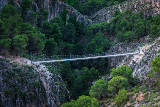Pedestrian suspension bridge on the El Saltillo trail in Canillas de Aceituno, Malaga.