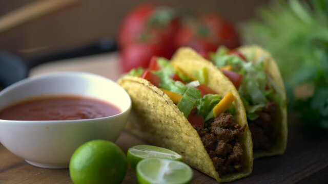 hard shell taco on wooden board with lime