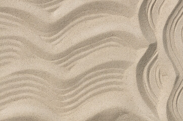 Fototapeta na wymiar wavy texture of sand in summer at sea