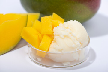 Mango butter and fresh mango fruit. Organic cosmetic, skin care, spa concept.