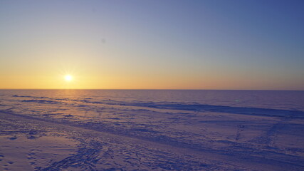 sunset in the winter on the white sea