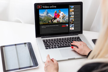 Woman watching videos online on laptop